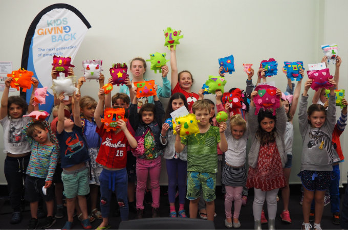 Kids sew a softie for kids in a shelter