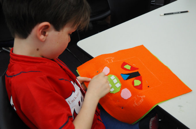 Kids sew a softie for kids in a shelter