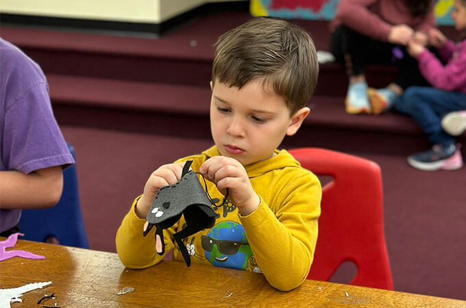 boy sewing a rabbit softie